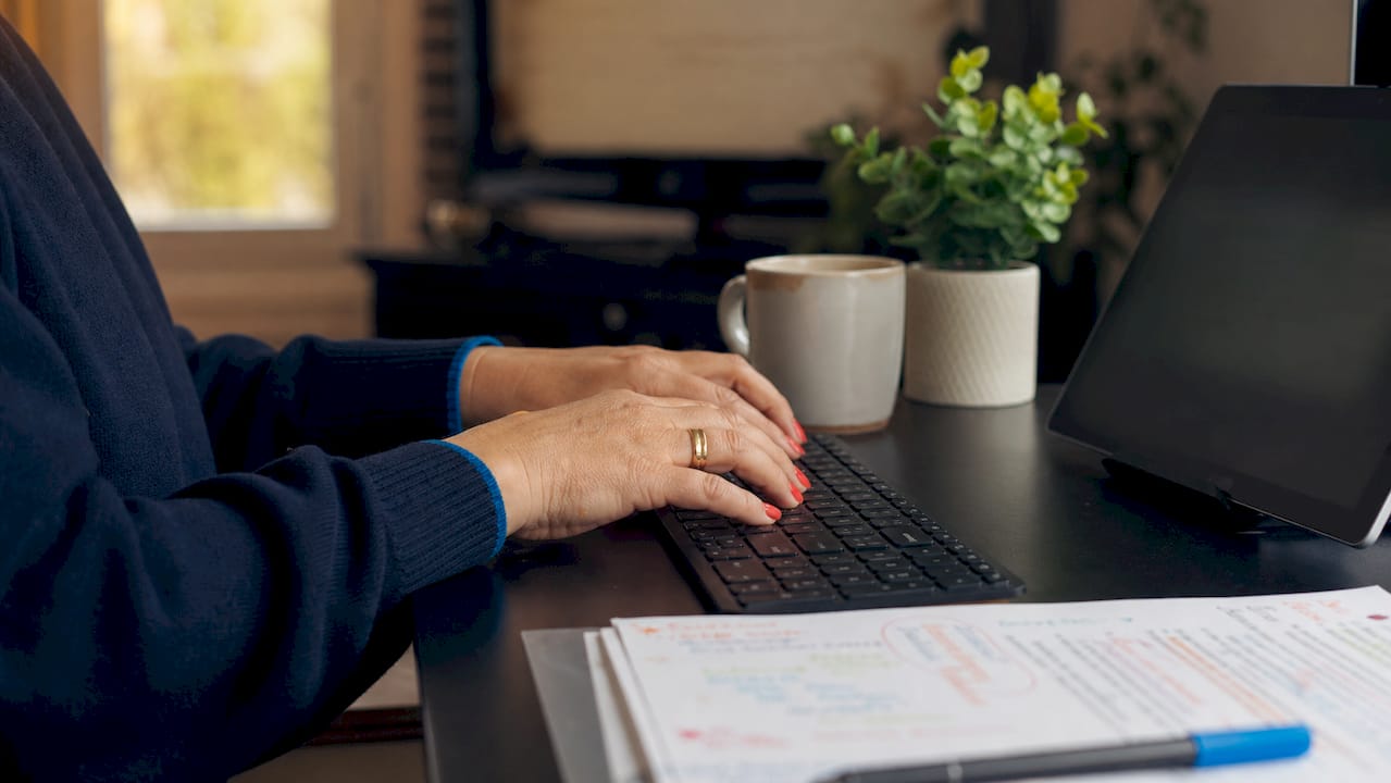 Hands typing admissions meta descriptions