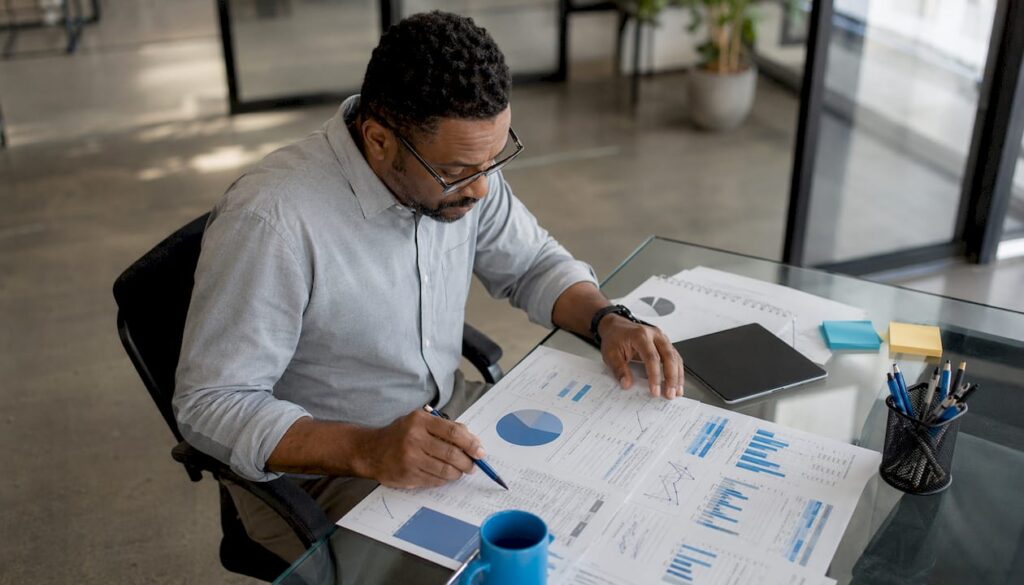 SEO analyst reviewing printed SEO reports